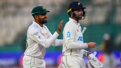 Babar Azam pats Devon Conway's back (AFP) Babar Azam pats Devon Conway's back (AFP)