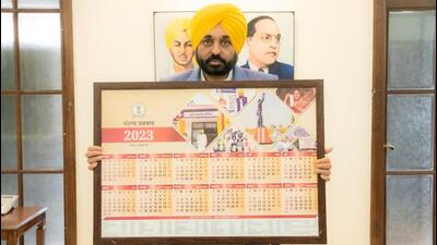 Punjab chief minister Bhagwant Mann with the state government’s 2023 calender in Chandigarh on Monday. (HT Photo)