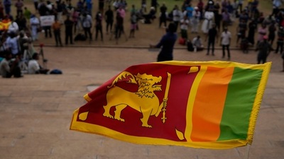 Sri Lanka Economic Crisis: A Sri Lankan flag is waved by a protester. (AP File) Sri Lanka Economic Crisis: A Sri Lankan flag is waved by a protester. (AP File)