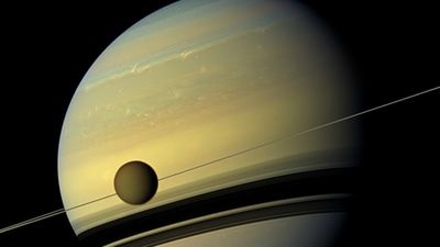 Saturn’s moon Titan is seen here as it orbits the planet. (File photo) (Photo Credit: NASA/ JPL-Caltech/Spac Science Institute) Saturn’s moon Titan is seen here as it orbits the planet. (File photo) (Photo Credit: NASA/ JPL-Caltech/Spac Science Institute)