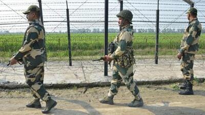 Border Security Force personnel walk along a fence at the India-Pakistan border on the outskirts of Amritsar in Punjab. (AFP File Photo)