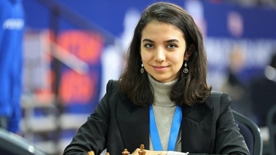 Sara Khadem: Sara Khadem of Iran sits in front of a chess board. (Reuters)