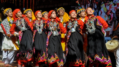People wearing traditional attire take out tableaux of traditional costumes and dishes during the Manali Winter Carnival 2023. (PTI)