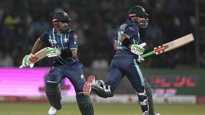 Babar Azam, left, and batting partner Mohammad Rizwan run between the wickets. (AP) Babar Azam, left, and batting partner Mohammad Rizwan run between the wickets. (AP)
