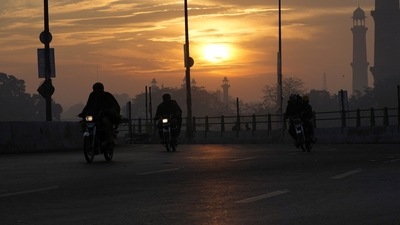 Pakistan: People ride a motorbike at sunrise on New Year's Day in the city of Lahore. (AP) Pakistan: People ride a motorbike at sunrise on New Year's Day in the city of Lahore. (AP)