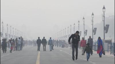 People take a stroll at Kartavya Path amid dense fog on a cold winter day in New Delhi. (ANI Photo) People take a stroll at Kartavya Path amid dense fog on a cold winter day in New Delhi. (ANI Photo)