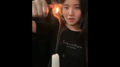 The image, taken from the viral Twitter video, shows the woman trying to reignite a candle using its smoke trail. (Twitter/@gunsnrosesgirl3) The image, taken from the viral Twitter video, shows the woman trying to reignite a candle using its smoke trail. (Twitter/@gunsnrosesgirl3)
