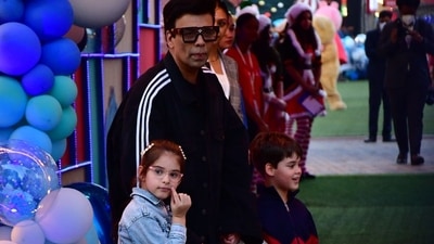 Karan Johar poses for the paps with his children Roohi and Yash Johar. (HT Photo/Varinder Chawla)