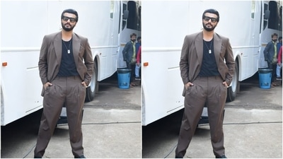Arjun picked a black T-shirt and teamed it with a grey suit and a pair of grey formal trousers. With a sleek golden chain, Arjun accessorised his look for the day. (HT Photos/Varinder Chawla) Arjun picked a black T-shirt and teamed it with a grey suit and a pair of grey formal trousers. With a sleek golden chain, Arjun accessorised his look for the day. (HT Photos/Varinder Chawla)