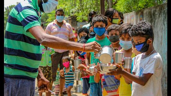 NGO workers distribute milk at a village during the nationwide lockdown due to the coronavirus pandemic, Santipur, April 4, 2020 (PTI)