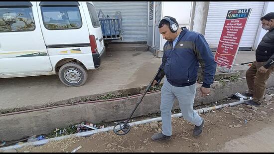 Officials of bomb disposal squad check streets a day after an IED explosion in the area, in Dhangri village of Rajouri on Tuesday. (PTI)