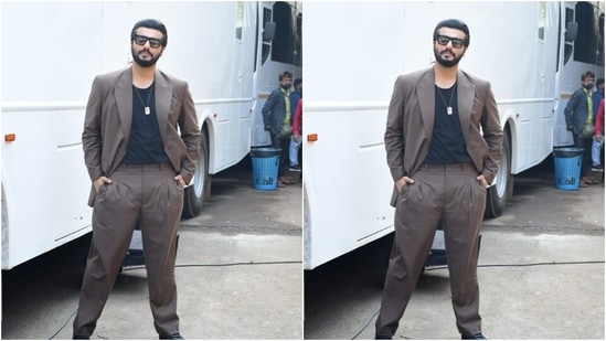 Arjun picked a black T-shirt and teamed it with a grey suit and a pair of grey formal trousers. With a sleek golden chain, Arjun accessorised his look for the day.&nbsp;(HT Photos/Varinder Chawla)