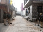 Delhi police personnel near the residence of the woman who died after being dragged by a car in Sultanpuri.