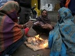 People warm themselves near a bonfire during cold winter on Wednesday morning in New Delhi. People warm themselves near a bonfire during cold winter on Wednesday morning in New Delhi.