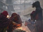 People sit around the bonfire to keep themselves warm on a cold winter day in Delhi NCR.(ANI) People sit around the bonfire to keep themselves warm on a cold winter day in Delhi NCR.(ANI)