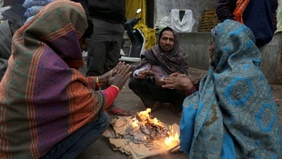 People warm themselves near a bonfire during cold winter on Wednesday morning in New Delhi. (PTI) People warm themselves near a bonfire during cold winter on Wednesday morning in New Delhi. (PTI)