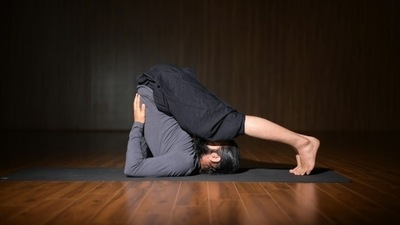 9. Halasana - Lie on your back with palms beside your body. Press your palms into the floor to lift your legs up and drop them behind your head. Use your palms to support the back if needed. Hold the asana for a while. Word of Advice If you have lumbago, neck pain, spondylitis and high blood pressure, please do not practice this posture. (Grand Master Akshar) 9. Halasana - Lie on your back with palms beside your body. Press your palms into the floor to lift your legs up and drop them behind your head. Use your palms to support the back if needed. Hold the asana for a while. Word of Advice If you have lumbago, neck pain, spondylitis and high blood pressure, please do not practice this posture. (Grand Master Akshar)