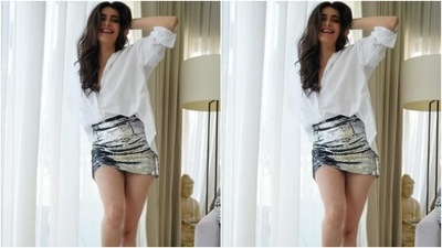 Karishma decked up in a white shirt and tucked it inside a silver sequined pencil short skirt. (Instagram/@karishmaktanna) Karishma decked up in a white shirt and tucked it inside a silver sequined pencil short skirt. (Instagram/@karishmaktanna)