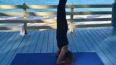 10. Sirshasana (Headstand) - Begin in Vajrasana. Place your elbows on the ground and interlock your palms. Your palms and elbows must form a triangle on the floor. Place the top of your head on the floor ahead of your palms. Let your palms support the back of your head. Walk your toes towards your head until your back straightens. First lift any one leg up and then slowly lift up the second leg. Word of Advice If you have lumbago, neck pain, spondylitis and high blood pressure, please do not practice this posture. (Photo by Paola Munzi on Unsplash) 10. Sirshasana (Headstand) - Begin in Vajrasana. Place your elbows on the ground and interlock your palms. Your palms and elbows must form a triangle on the floor. Place the top of your head on the floor ahead of your palms. Let your palms support the back of your head. Walk your toes towards your head until your back straightens. First lift any one leg up and then slowly lift up the second leg. Word of Advice If you have lumbago, neck pain, spondylitis and high blood pressure, please do not practice this posture. (Photo by Paola Munzi on Unsplash)