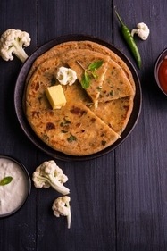 Gobi paratha is rich in fibre which further helps in lowering the cholesterol amount of the body. (Unsplash)