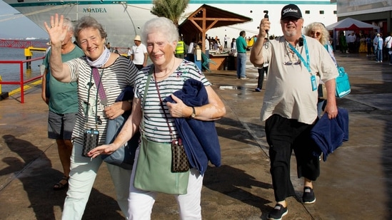 Tourists of different nationalities from European countries come ashore from the MS Amadea cruise ship at the port of El Guamache on Isla Margarita, Nueva Esparta state, Venezuela.(AFP)