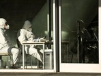 Covid In China: Security guards wearing personal protective equipment (PPE) amid the Covid-19 pandemic sit at an entrance of a building in Beijing. Covid In China: Security guards wearing personal protective equipment (PPE) amid the Covid-19 pandemic sit at an entrance of a building in Beijing.