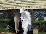 Hong Kong: Officers in protective suits leave a closed pet shop in Mong Kok district.