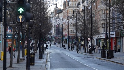 UK Weather: People walk along a shopping street, ahead of stores opening for the traditional Boxing Day sales in London. (Reuters)
