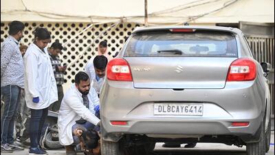 Forensic experts examining the car. (HT PHOTO) Forensic experts examining the car. (HT PHOTO)