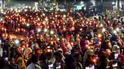 Residents take out a candle march against the Uttarakhand High Court's order for removal of encroachments from the railway land, in Haldwani. (PTI)