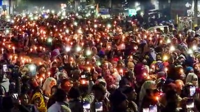 Residents take out a candle march against the Uttarakhand High Court's order for removal of encroachments from the railway land, in Haldwani. (PTI)