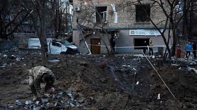 Russia-Ukraine War: A serviceman collects fragments of missile in a crater left by a Russian strike in Kyiv. (AFP)