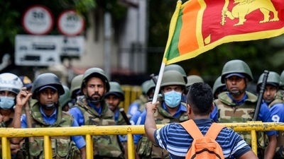 Sri Lanka Economic Crisis: A demonstrator waves a Sri Lankan flag, Colombo. (File) Sri Lanka Economic Crisis: A demonstrator waves a Sri Lankan flag, Colombo. (File)