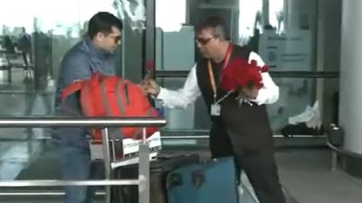 A passengers receiving a rose from an airport official at Goa’s Manohar International Airport on Thursday. (ANI)