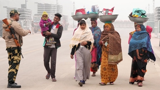 Workers visit Kartavya Path, in New Delhi, on January 5. A cold wave is declared in the region when the minimum temperature is 4.5 degrees or more below the normal mark, or when it drops to 4 degrees or lower.&nbsp;(Atul Yadav / PTI)