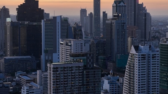 Covid In Thailand: Skyscrapers are photographed against the setting sun in Bangkok, Thailand.(Reuters)