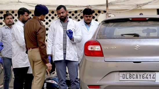 FSL team conducts an inspection of the car along with the team of police at Sultanpuri police station in the Kanjhawala death case, in New Delhi on Wednesday. (ANI Photo/Ayush Sharma) 