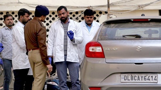 FSL team conducts an inspection of the car along with the team of police at Sultanpuri police station in the Kanjhawala death case, in New Delhi.