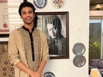 Actor Babil Khan stands next to a photograph of his father, late actor Irrfan Khan. Actor Babil Khan stands next to a photograph of his father, late actor Irrfan Khan.