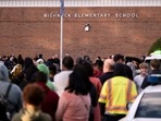 Students and police gather outside of Richneck Elementary School after a shooting.(AP) Students and police gather outside of Richneck Elementary School after a shooting.(AP)