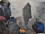 People warm themselves around a bonfire on a cold winter morning at Ghazipur market in New Delhi. (Raj K Raj/HT Photo) People warm themselves around a bonfire on a cold winter morning at Ghazipur market in New Delhi. (Raj K Raj/HT Photo)