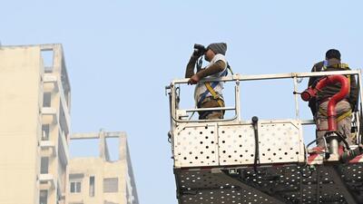 Forest and fire department officials search for the leopard at Ajnara Le Garden Society in Greater Noida on Friday. (Sunil Ghosh/HT Photo) Forest and fire department officials search for the leopard at Ajnara Le Garden Society in Greater Noida on Friday. (Sunil Ghosh/HT Photo)