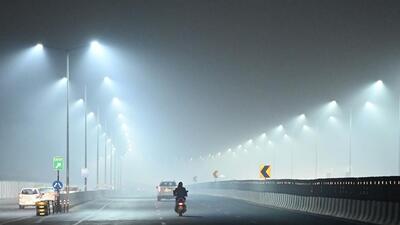 Gurugram, India-January 06, 2023: Commuters are seen wearing warm clothes while riding the two-wheelers on a cold winter and foggy night at Gurugram-Sohna elevated road near Rajiv chowk, in Gurugram, India, on Friday, 06 January 2023. (Photo by Parveen Kumar/Hindustan Times) Gurugram, India-January 06, 2023: Commuters are seen wearing warm clothes while riding the two-wheelers on a cold winter and foggy night at Gurugram-Sohna elevated road near Rajiv chowk, in Gurugram, India, on Friday, 06 January 2023. (Photo by Parveen Kumar/Hindustan Times)