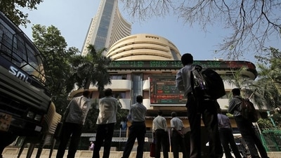 People look at a screen displaying the Sensex results on the facade of the Bombay Stock Exchange (BSE) building in Mumbai. (REUTERS)