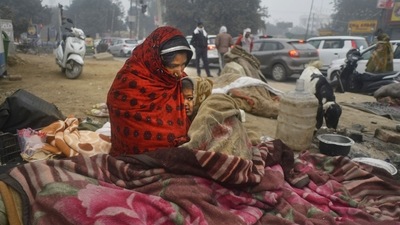 Homeless people on a pavement during a cold and foggy winter morning, in Gurugram on Friday. (PTI) Homeless people on a pavement during a cold and foggy winter morning, in Gurugram on Friday. (PTI)