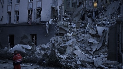 Russia-Ukraine War: An emergency worker walks in front of a damaged hotel following a Russian attack in Kyiv. (AP)