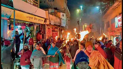 Residents of Joshimath take out a procession to protest land subsidence that has caused cracks in at least 500 homes, on Wednesday night. (ANI)