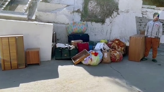 Belongings of people seen outside a house where a crack developed as a result of the continued land subsidence, in Joshimath, Uttarakhand. (ANI Photo)