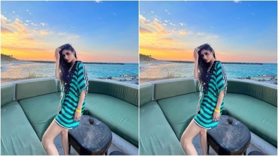 Mouni decked up in a black and green striped short dress and let her hair down to match the beach vibes.&nbsp;(Instagram/@imouniroy)