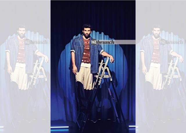 Aditya says, “Over the years, I’d play [the guitar] to keep myself entertained. It’s been my constant companion, I would say, for the last 19 years now. It’s been a while!”; Denim shirt by Space; Top by Saaksha & Kinni; Bottoms by Struct; Boots by Escaro Royale